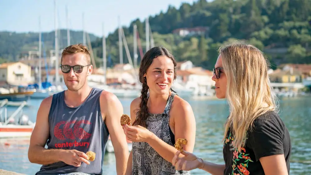 Friends eating Greek food in Lakka