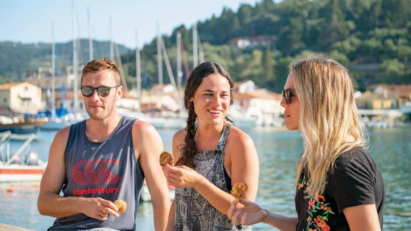 Group of people enjoy some Greek food on the waterfront in Lakka