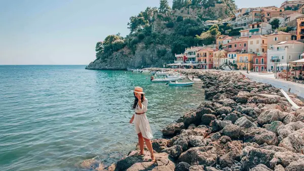 Woman standing on the rocks on the waterfront of Parga