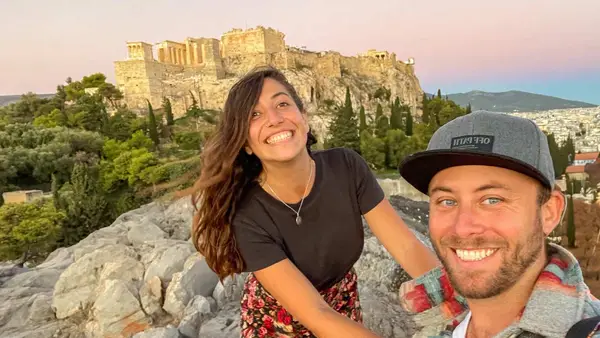 Couple pose for a selfie in front of the Acropolis