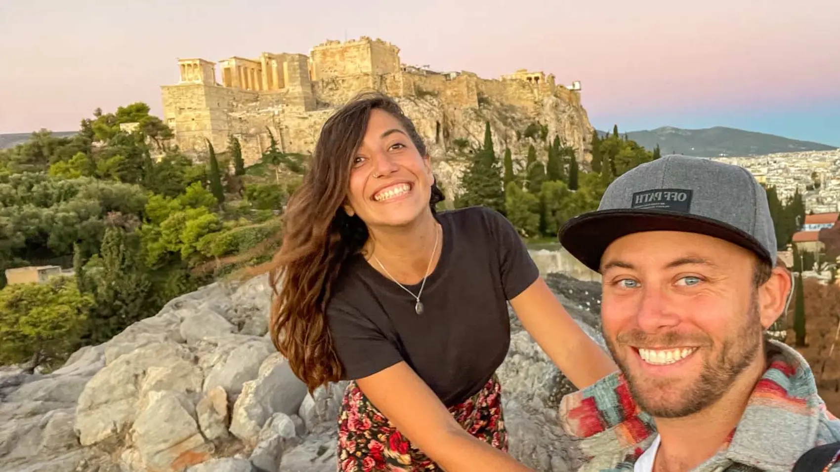 Couple pose for a selfie in front of the Acropolis