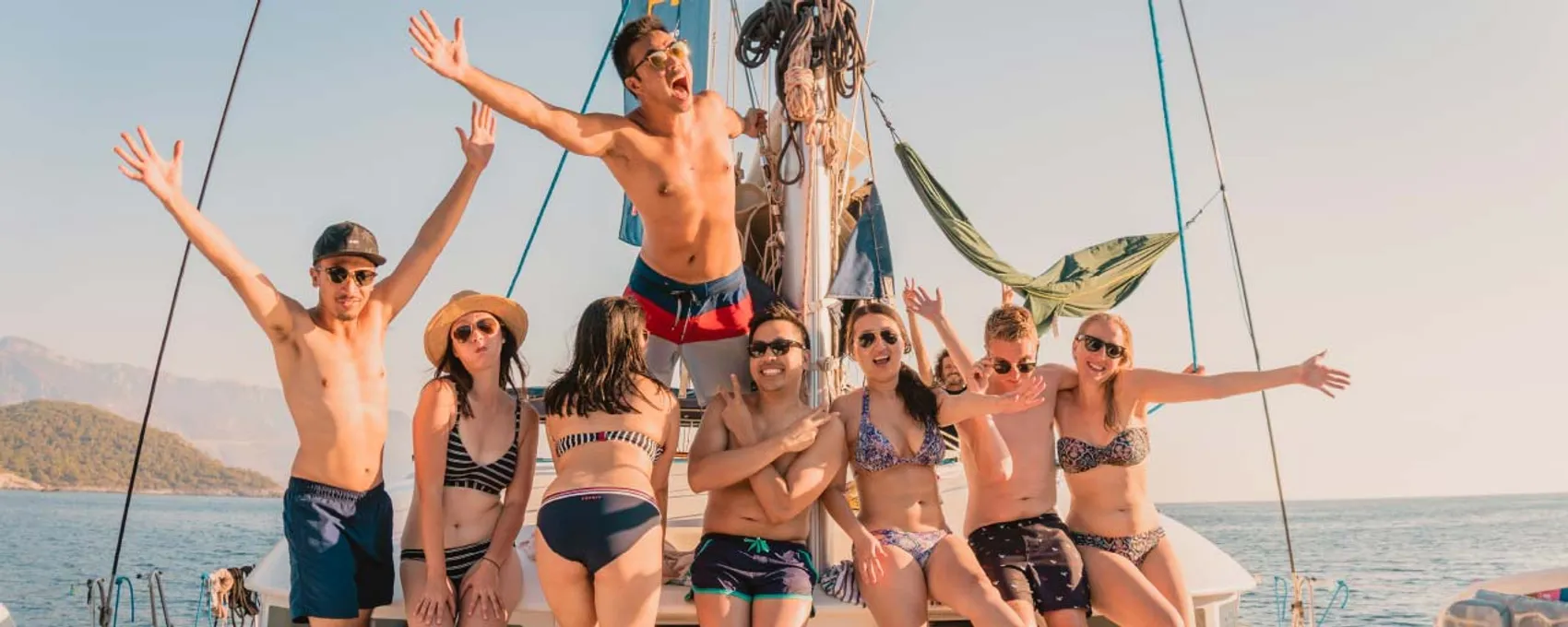 Group of MedSailors guests posing for a photo on a yacht