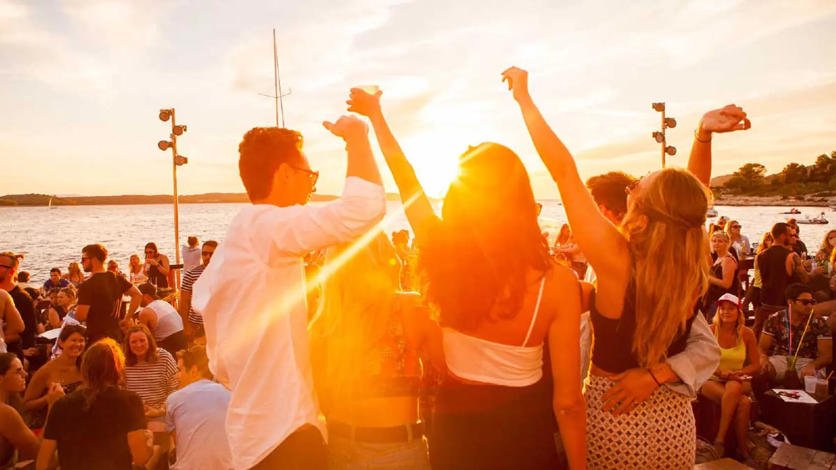 Group dancing at Hula Hula bar at sunset