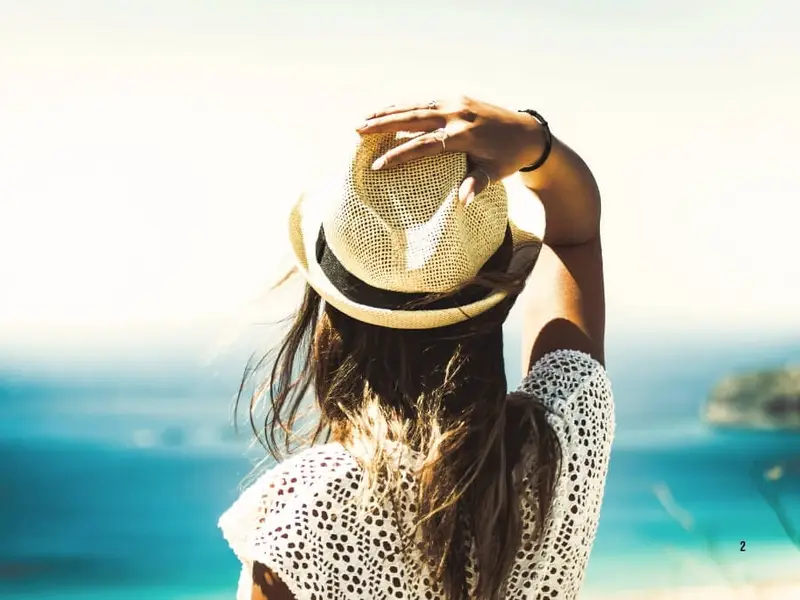 Premium Mediterranean yacht holiday scene with a traveller in a straw sun hat overlooking turquoise sea views, ideal for a MedSailors luxury sailing trip in Greece or Croatia.