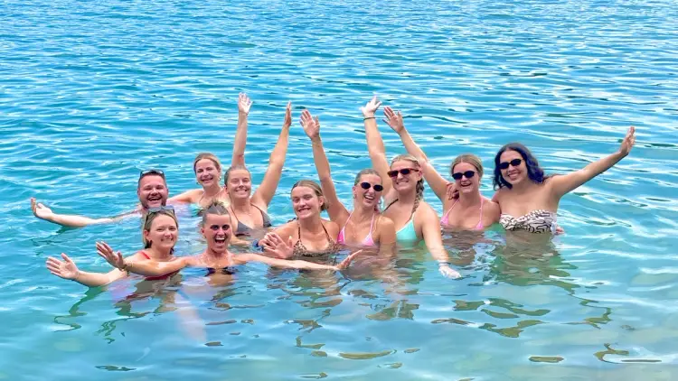 MedSailors travellers swimming together in the Adriatic Sea during a Croatia island-hopping sailing holiday in late summer.