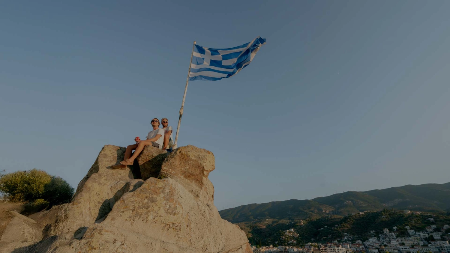 Two people up a viewpoint in Poros, Greece