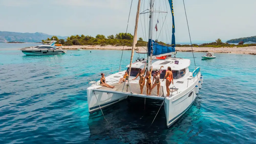 Group of friends on the bow of a catamaran