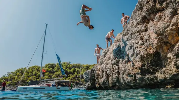Man doing a cliff jump into water in Croatia