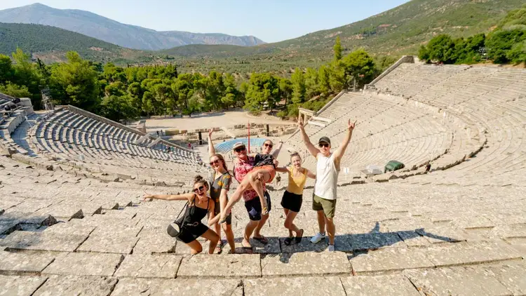 Group of guests pose for at the Epidavros ruins in Greece