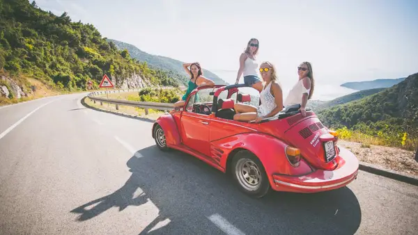 Group of people in a VW Beetle on Vis