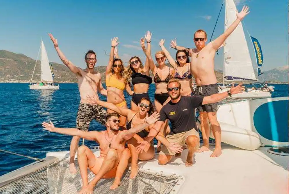 Group of friends pose for a photo on a yacht