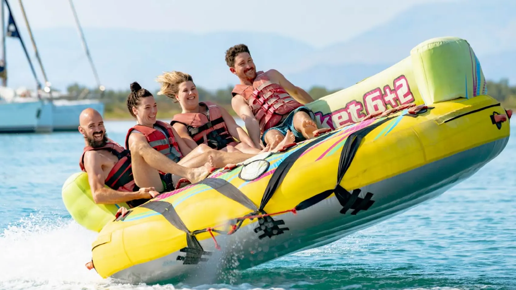 Group of friends enjoying watersports at Iggy Beach