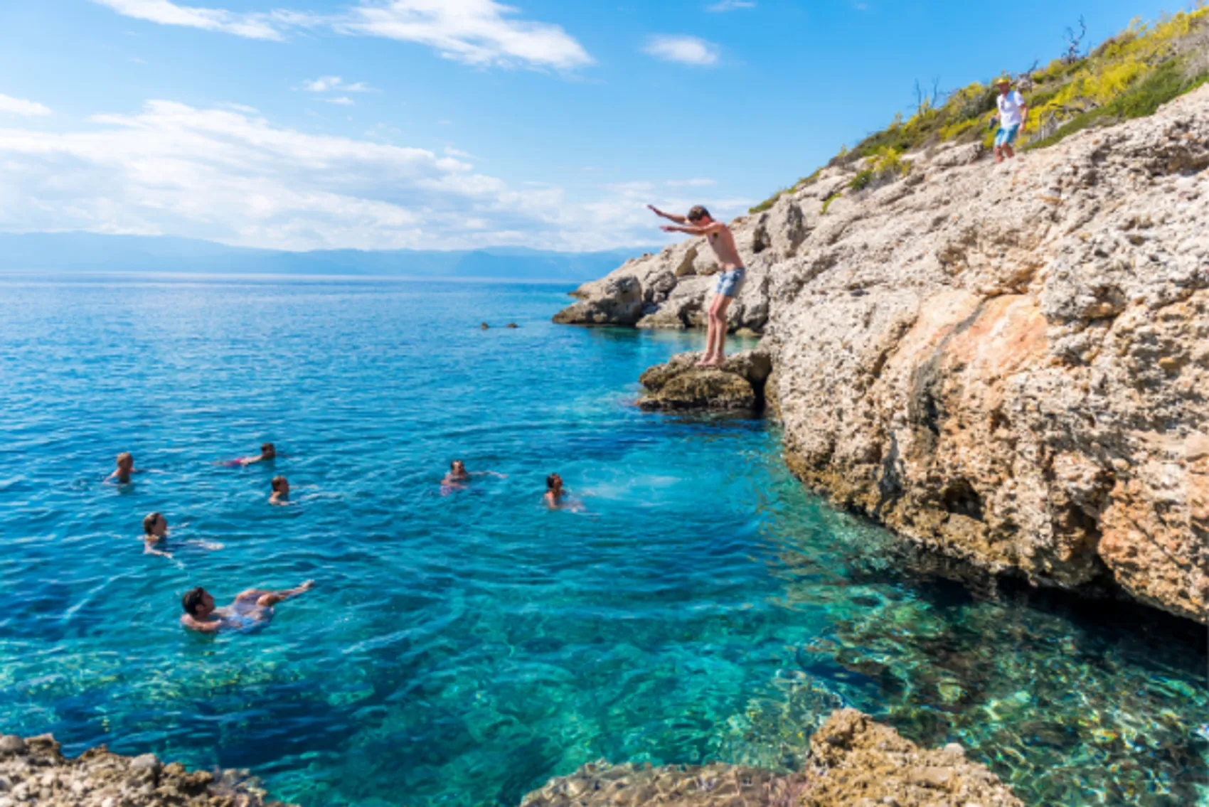 Guest jumping into crystal blue waters