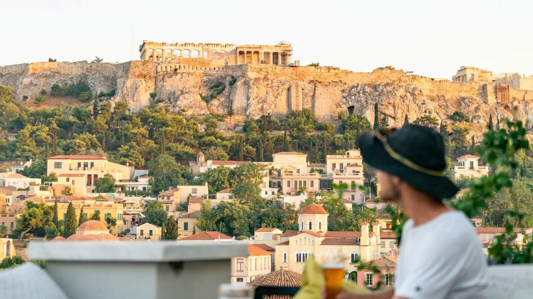 Man on a roof terrace overlooking the Acropolis in Athens