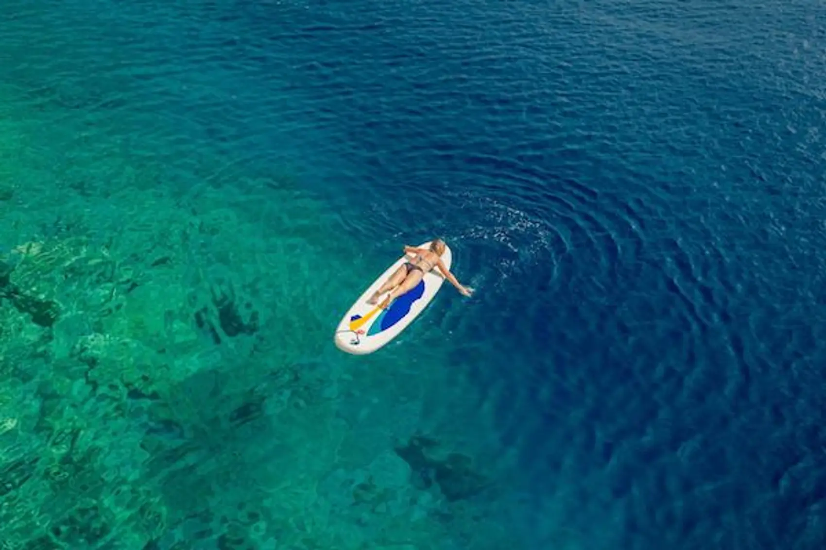 A girl paddle boarding in Croatia.