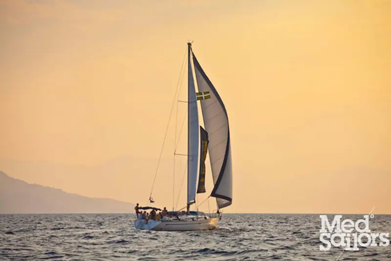 Sailing a yacht - sunset on the water