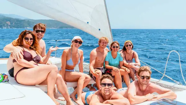 Group of friends pose for a photo on a yacht