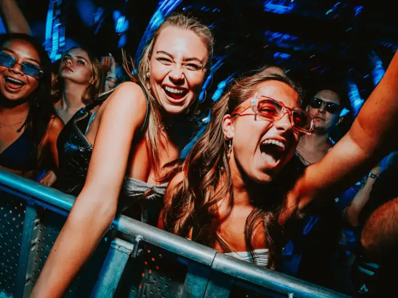 Festival travellers cheering at the front of the crowd during Ultra Europe in Split, Croatia, showing the energy of booking tickets early for one of Europe’s biggest summer music festivals. Image for a budget travel guide about saving money on Ultra Europe tickets, avoiding last-minute prices, and planning a Croatia festival holiday with MedSailors.