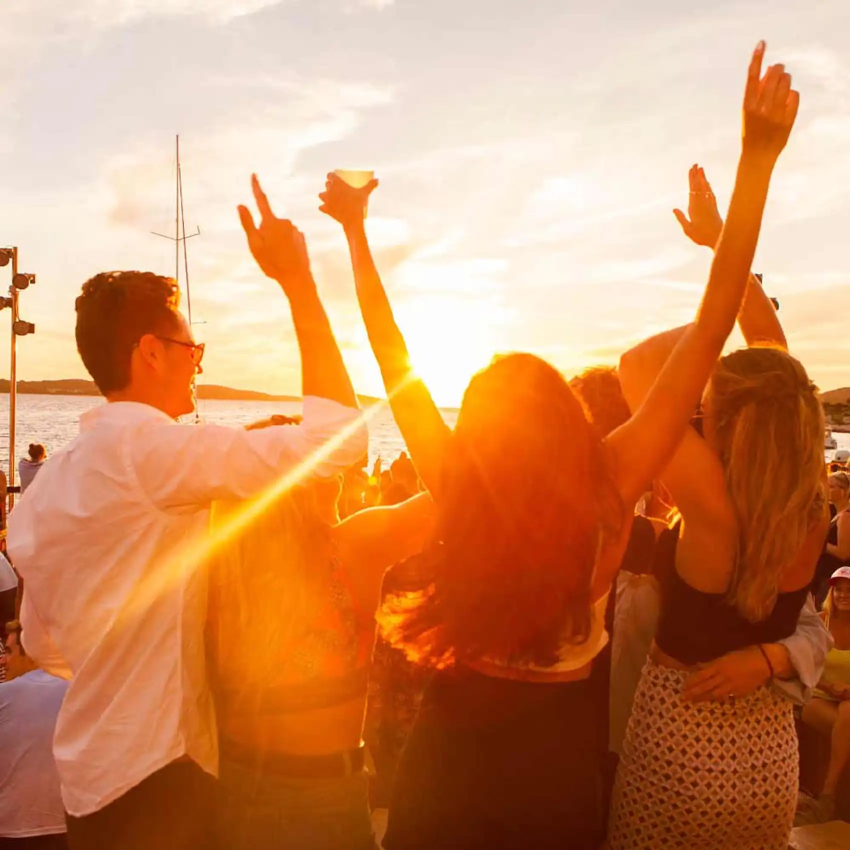 Friends dance at sunset at Hula Hula Bar in Croatia