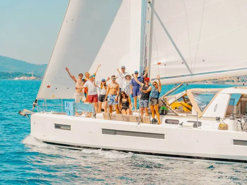 A lively group sailing aboard a luxury yacht, embracing the best of Greek island hopping, social adventure travel, and Mediterranean summer vibes.