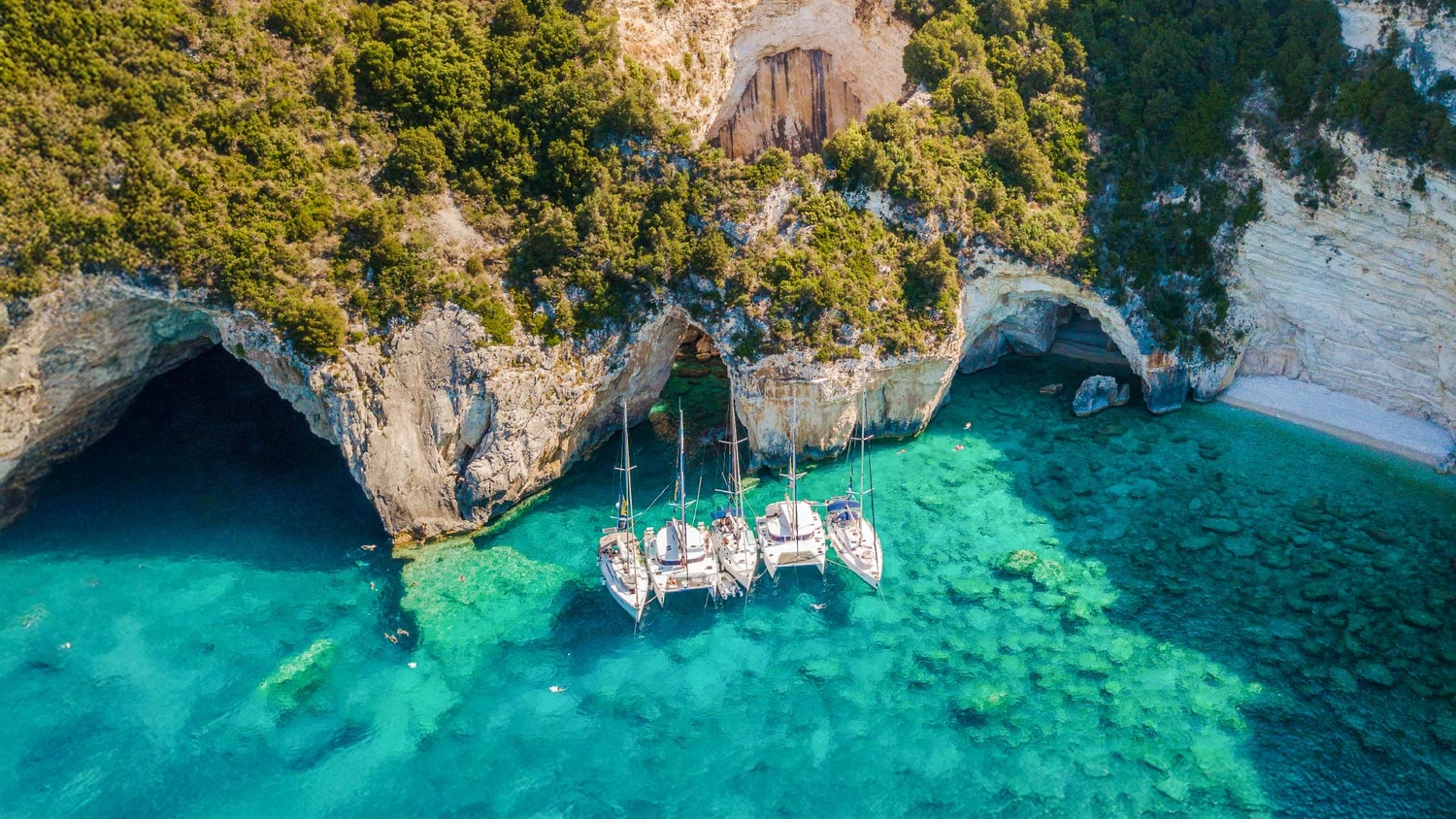 MedSailor yachts anchored together in a beautiful blue bay in Greece