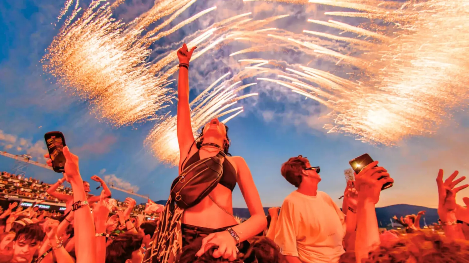 Festival crowd watching fireworks at Ultra Europe in Split, Croatia, with travellers celebrating during one of Europe’s biggest summer music festivals. Header image for a budget guide to Ultra Europe 2026, covering how to save money on tickets, accommodation, food, drinks, transport, and how to combine the festival with a Croatia sailing holiday.