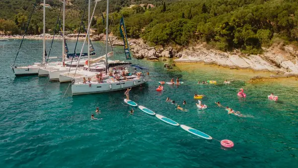 MedSailors yachts rafted together in Greece with some paddle boards lined up