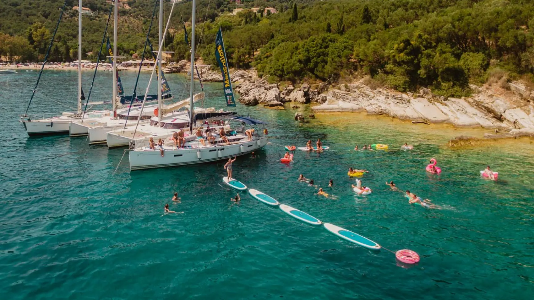 MedSailors yachts rafted together in Greece with some paddle boards lined up