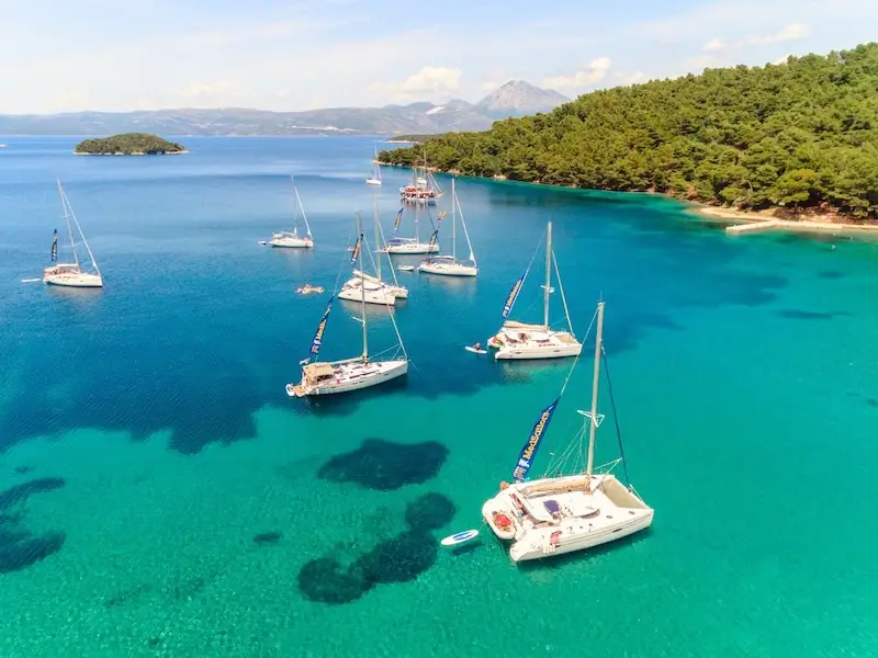 MedSailors sail Croatia flotilla anchored in a b right blue bay along the Dalmatian coast near Dubrovnik.