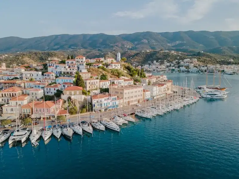Aerial shot of Poros Greece in the Saronic islands, one of the best nightlife destinations in the Mediterranean and a better alternative to Mykonos and Ios for nightlife.