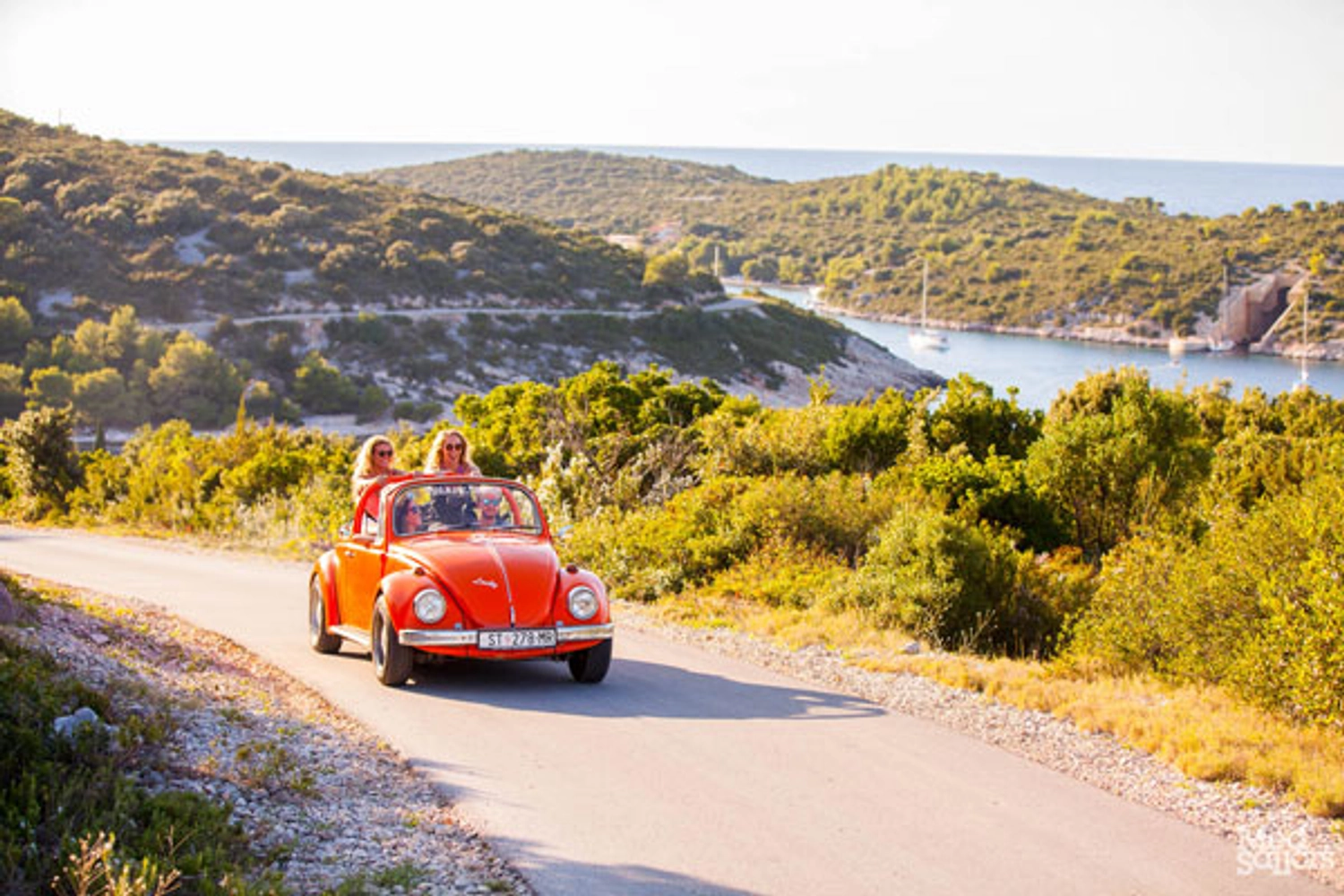 Group in a VW Beetle car driving in Croatia