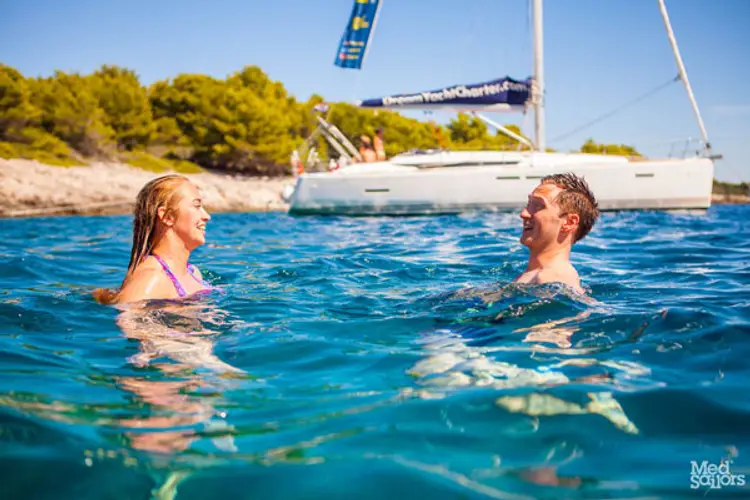 Couple swim in the ocean