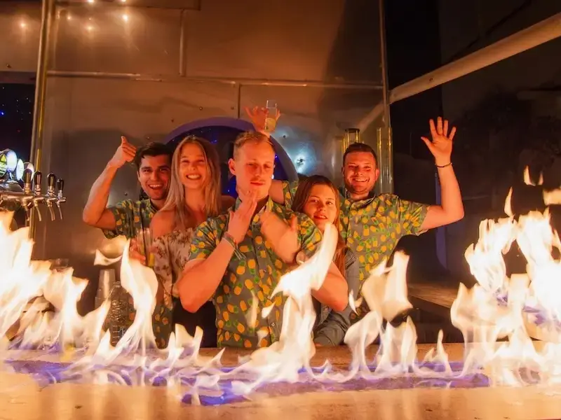 Group of travellers partying on a Greek island in the Saronic while on a Greece budget travel adventure with MedSailors.