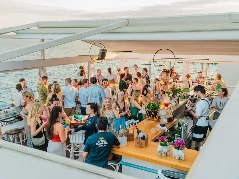 A photo of a seaside cocktail bar in Greece with young travellers partying while on a sail week with MedSailors.