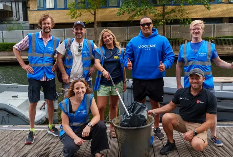 Group of MedSailors staff pose for a photo during a canal clean up