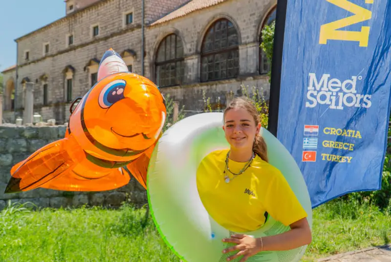 MedSailors staff member holding some floaties for recycling