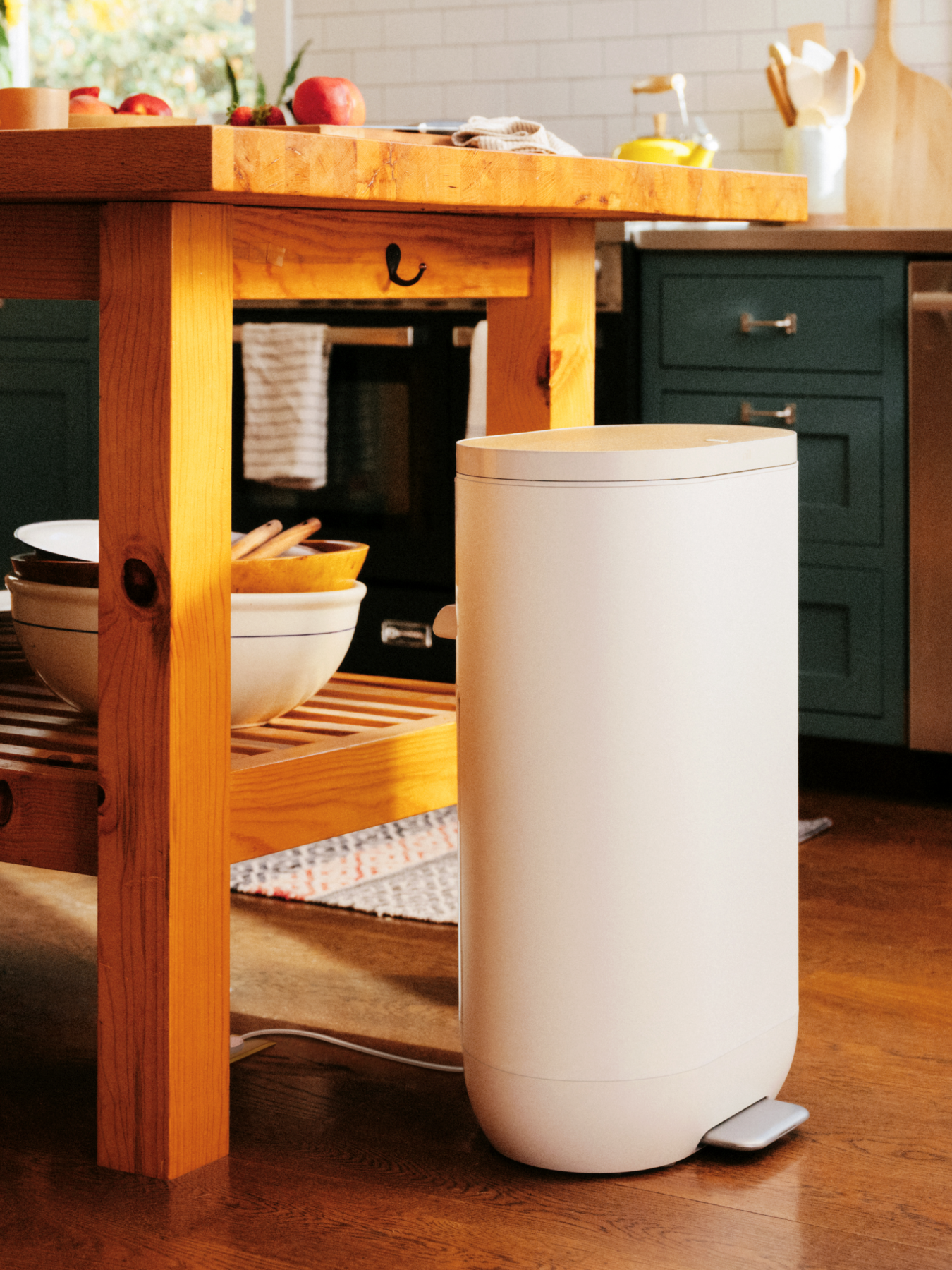 A Mill kitchen bin at home in a classic, open kitchen. 