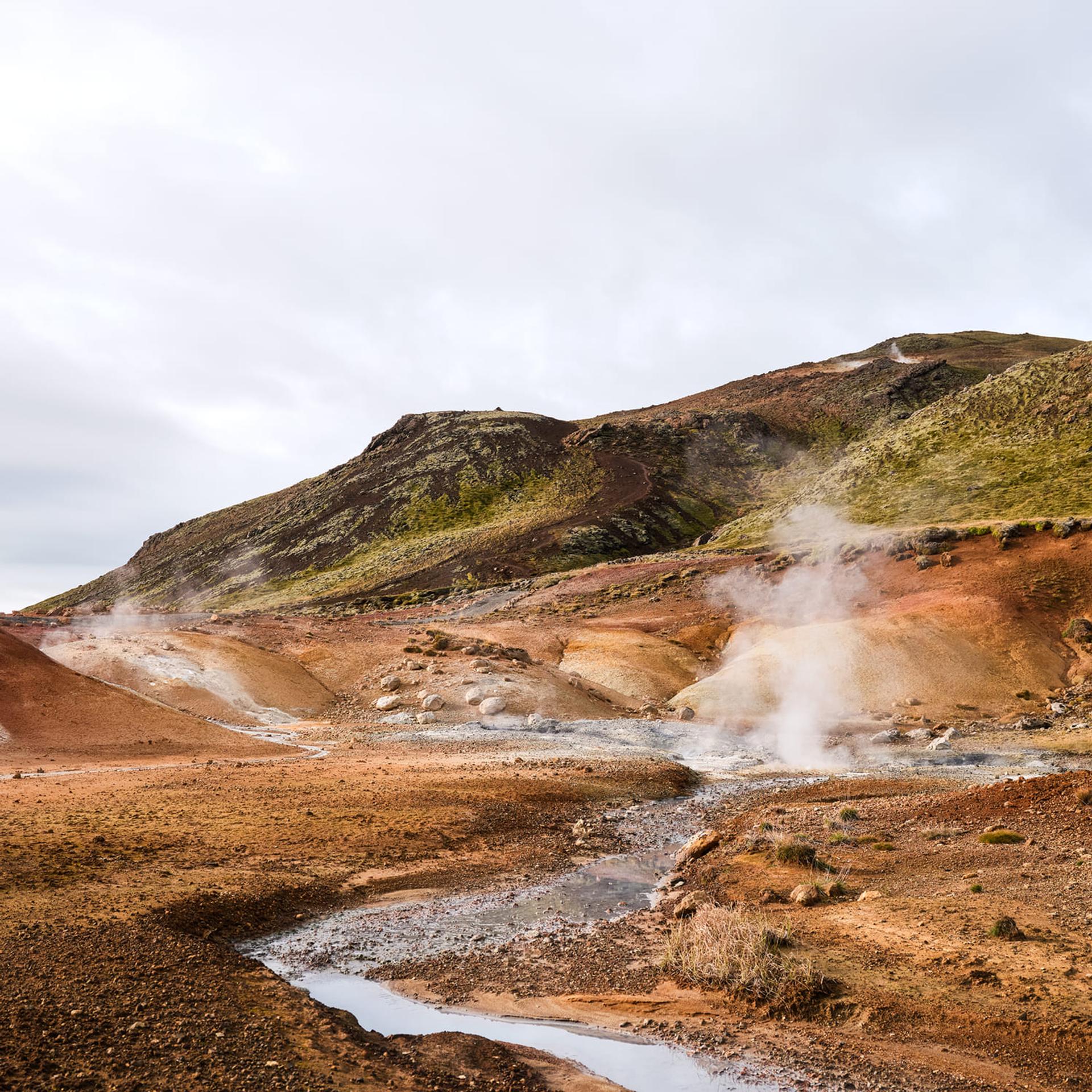 Volcanic Hills in Reykjavik with steam blowing through the Earth