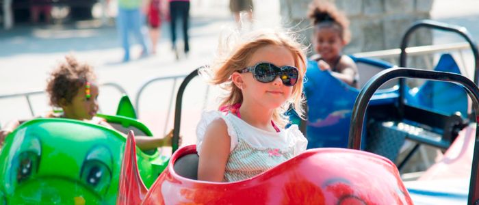 Small girl riding fish ride at DelGrosso's Park