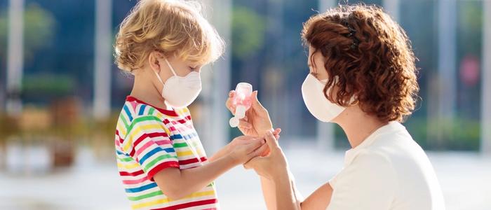 Mother and Son with masks and hand sanitizer