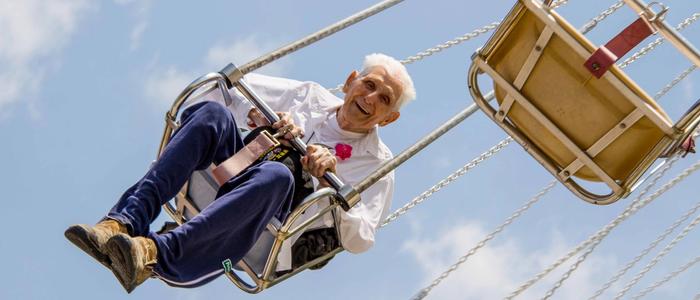Man riding the Yo-Yo Swing Ride at DelGrosso's Park.