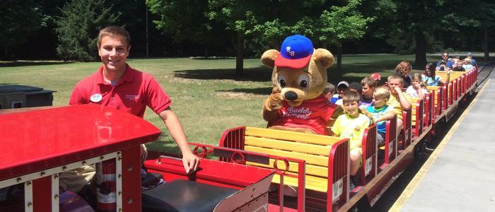 Children riding the Train at DelGrosso's Park with Buddy Bear