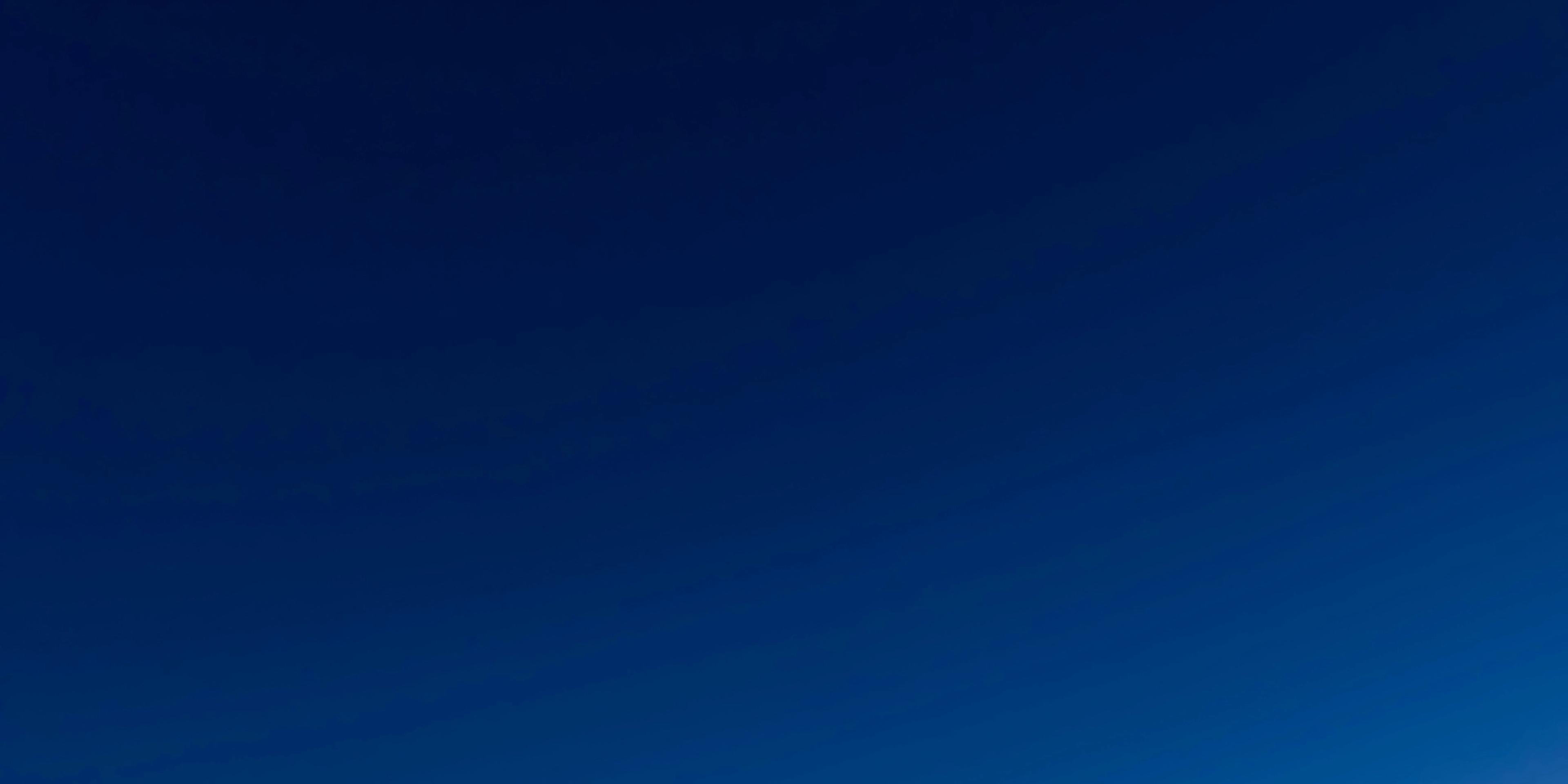 a dark blue sky with a white gradient in the middle