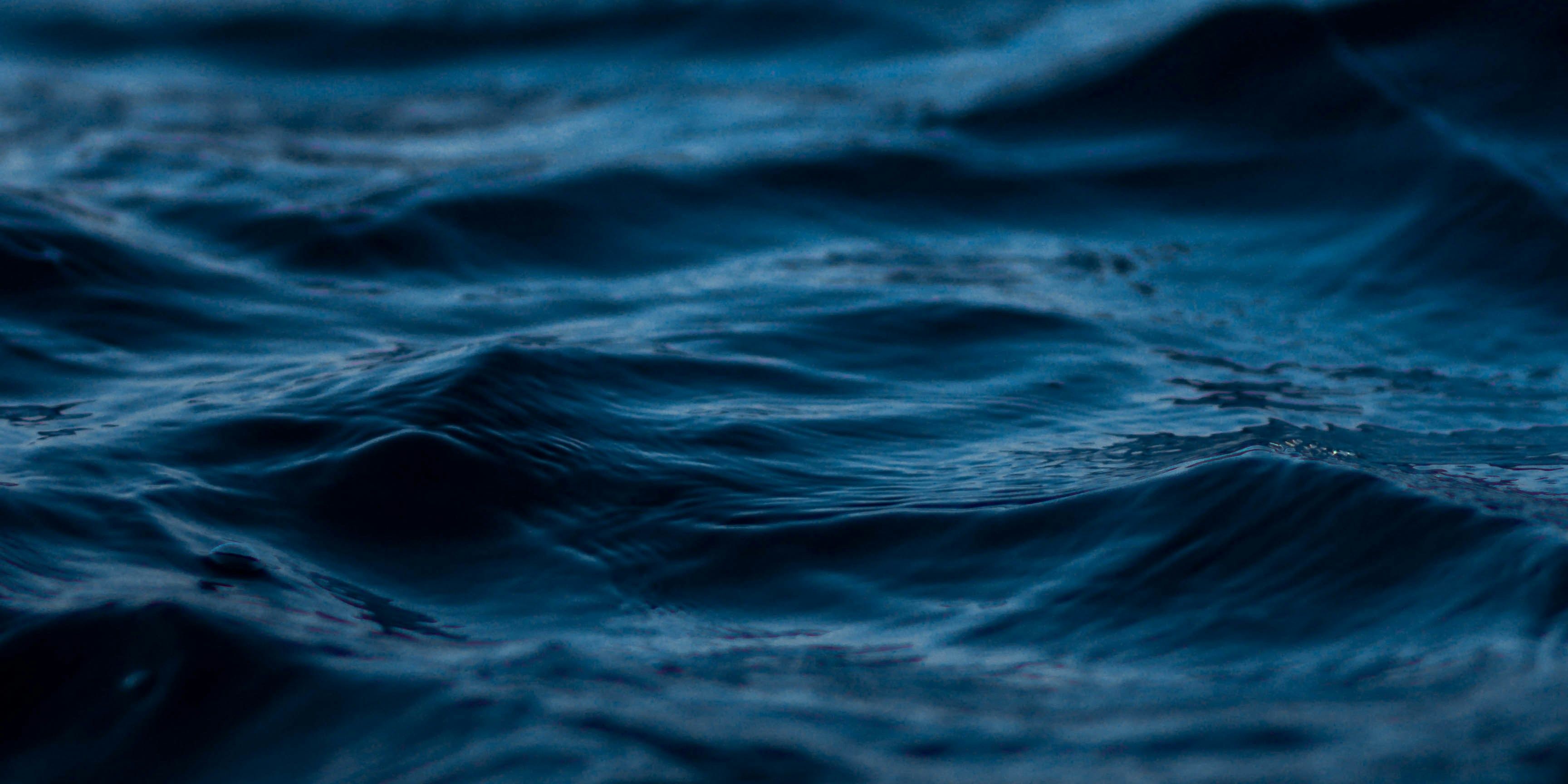 a close up of a dark blue ocean with waves