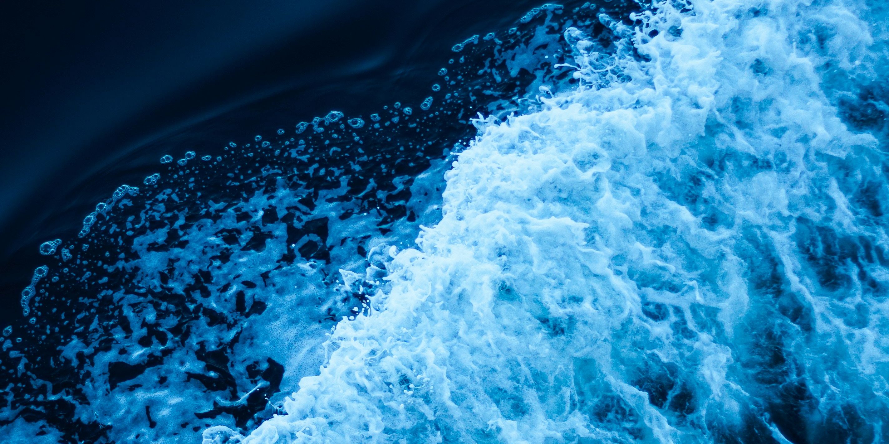 an aerial view of a wave in the ocean