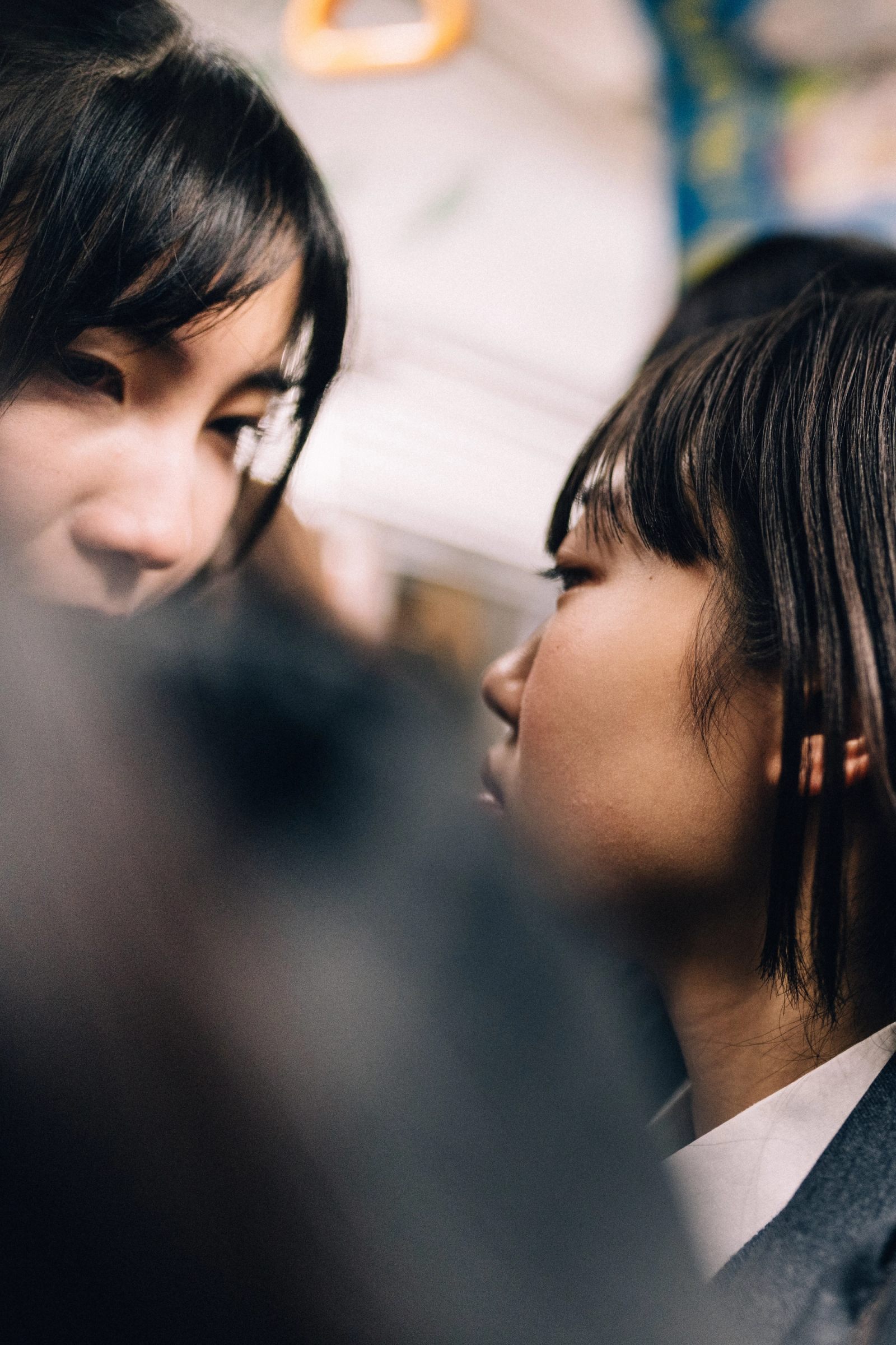 Two young people in close profile in a quiet moment, shallow focus.