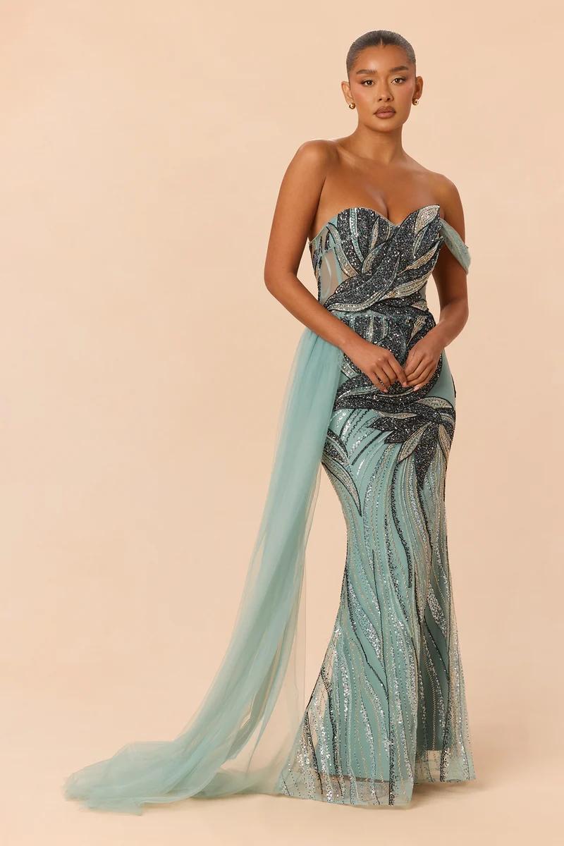Glamorous seafoam green embellished strapless evening gown featuring silver beaded patterns and a side tulle train for formal events.