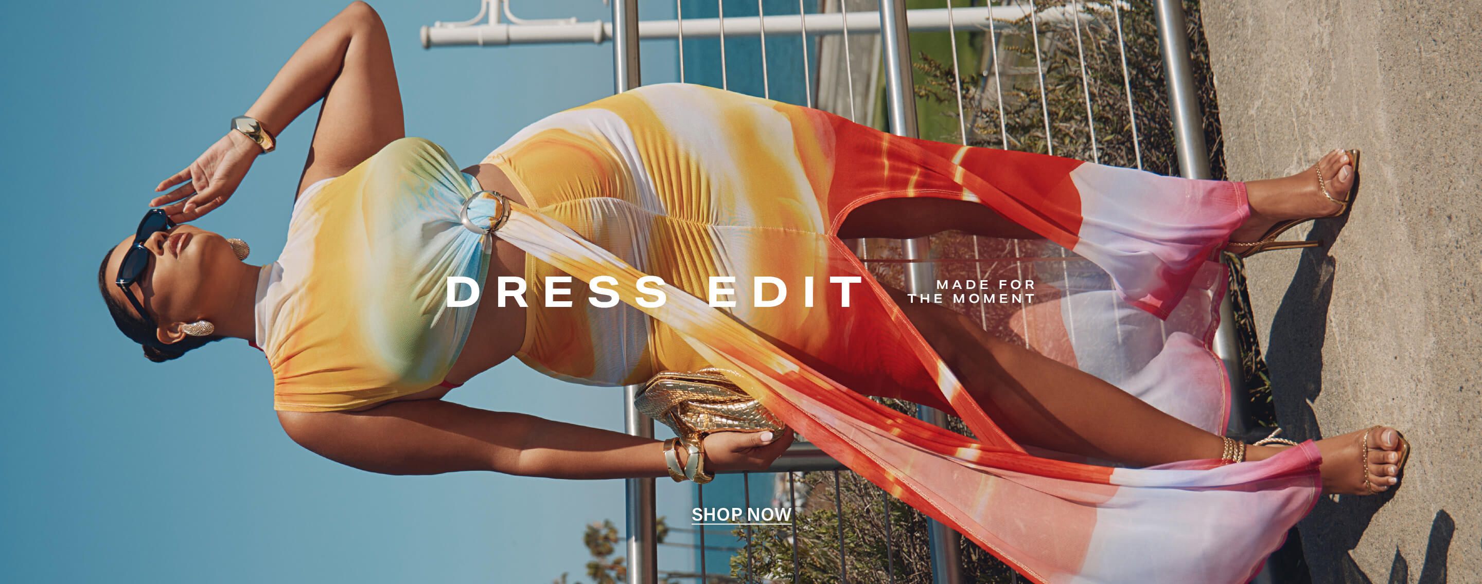 Confident model in a vibrant sunset tie-dye cut-out midi dress with a high slit, accessorized for a summer style moment. Shop the Dress Edit!