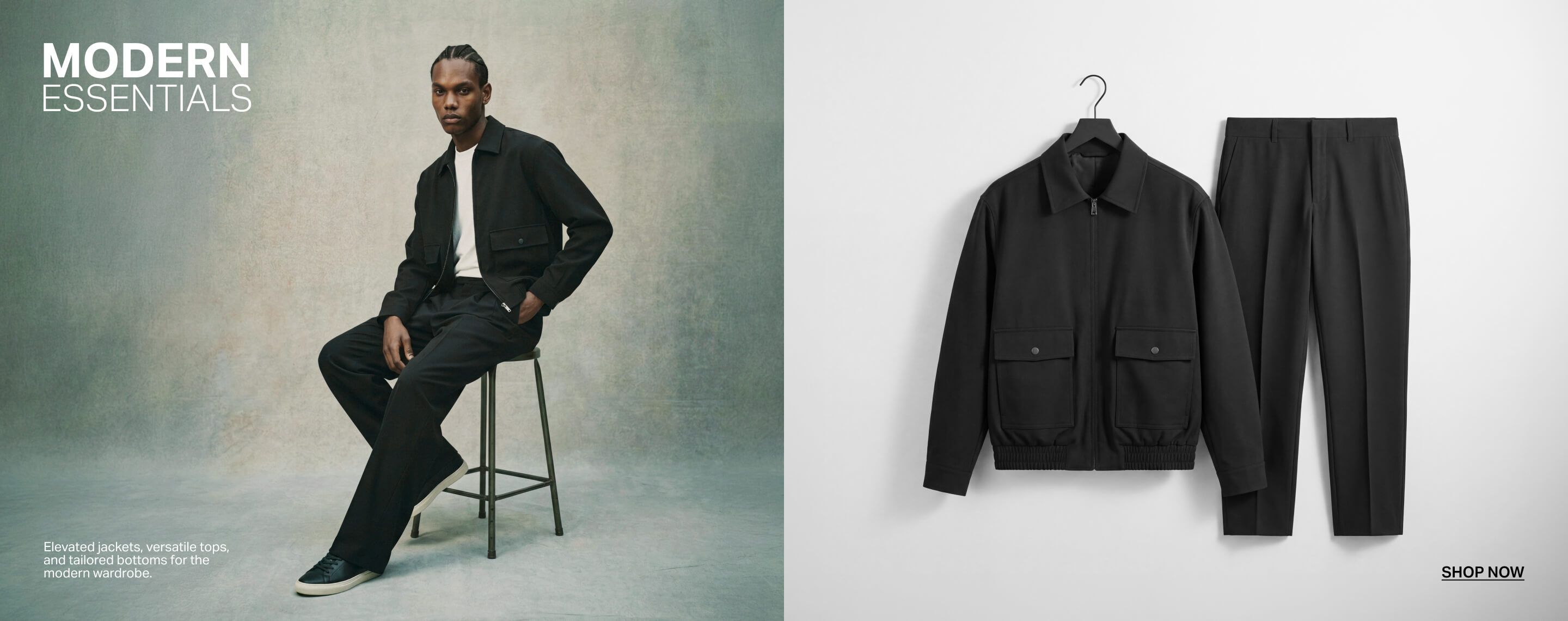 Man models modern essential black zip jacket, white tee, black pants, and sneakers, sitting on a stool. Shop sleek men's minimalist fashion.