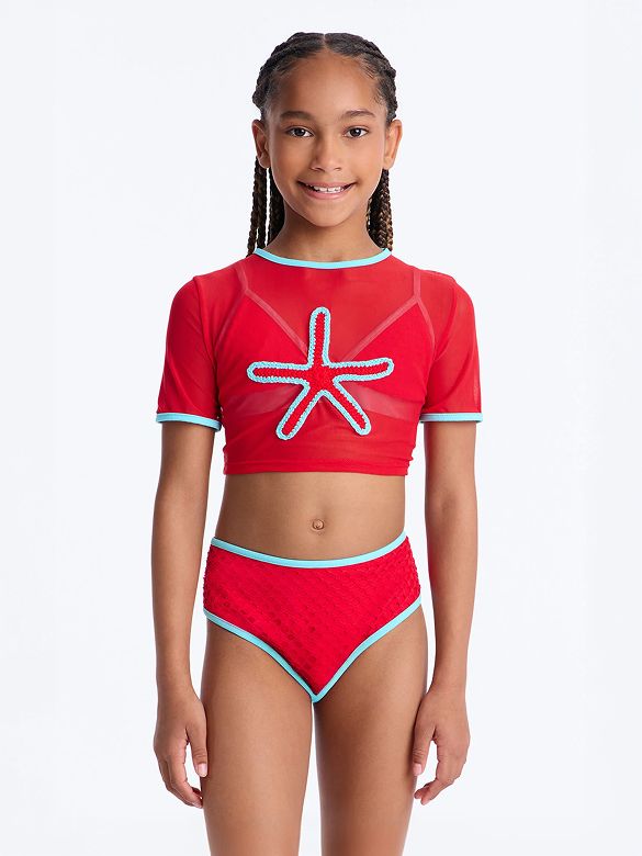 Smiling girl wears a red mesh two-piece swimsuit. Features a blue starfish top and textured high-waisted briefs. Perfect girls beachwear for summer.